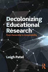 a book cover with a black-gray background resembling outer space, with some points of light. the title is in white and reads "decolonizing educational research"